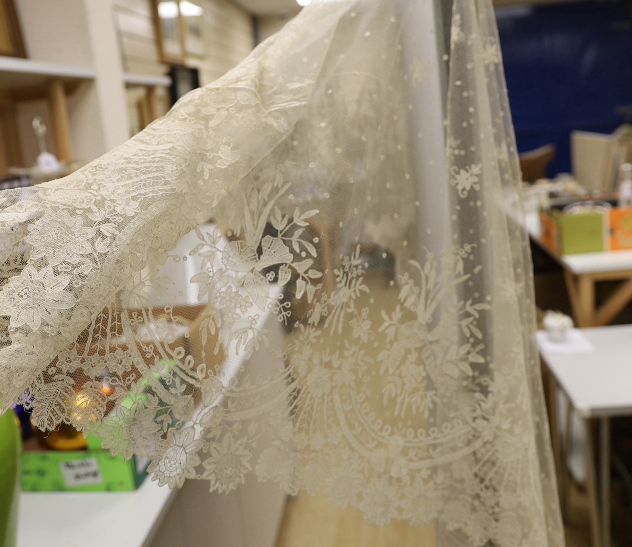 A 19th century Brussels bobbin lace wedding veil with point de gaze needle lace border and insertions, 196cm x 192cm